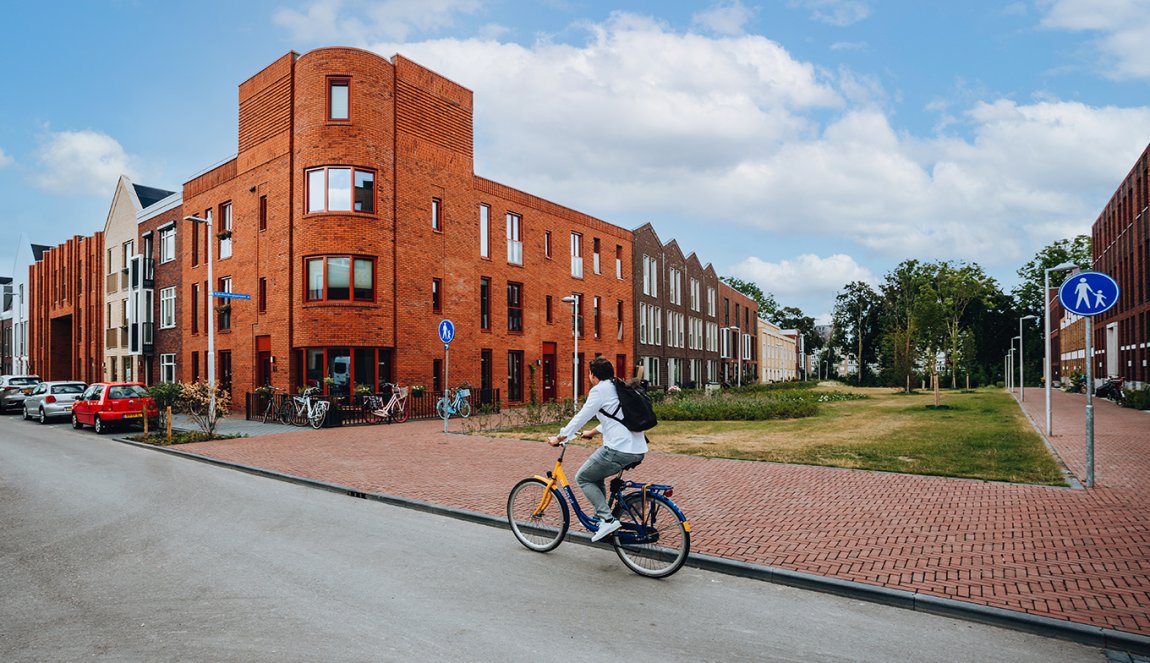 Utrecht Leeuwesteyn cyclist along block of houses