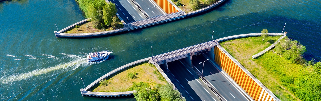 Aqueduct Veluwemeer, aerial view from the drone. A sailboat sails through the aqueduct on the lake above the highway Harderwijk