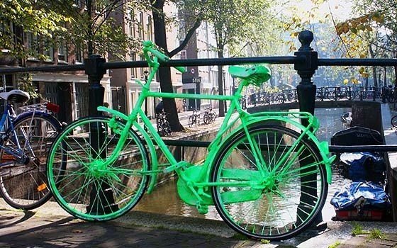 A bright green bike on a canal