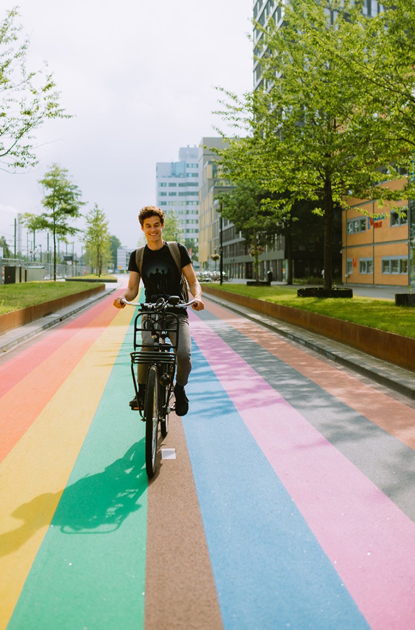 Man bikes across rainbow bike path in Utrecht