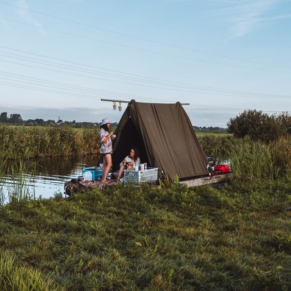Two ladies on their raft from Flotten in the meadow near Waterland Two ladies on their raft from Flotten in the meadow near Waterland