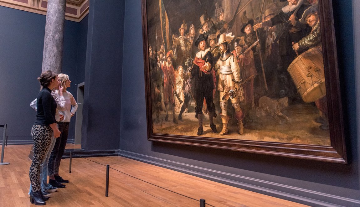 Visitors view painting De Nachtwacht by Dutch painter Rembrandt van Rijn Visitors view painting De Nachtwacht by Dutch painter Rembrandt van Rijn