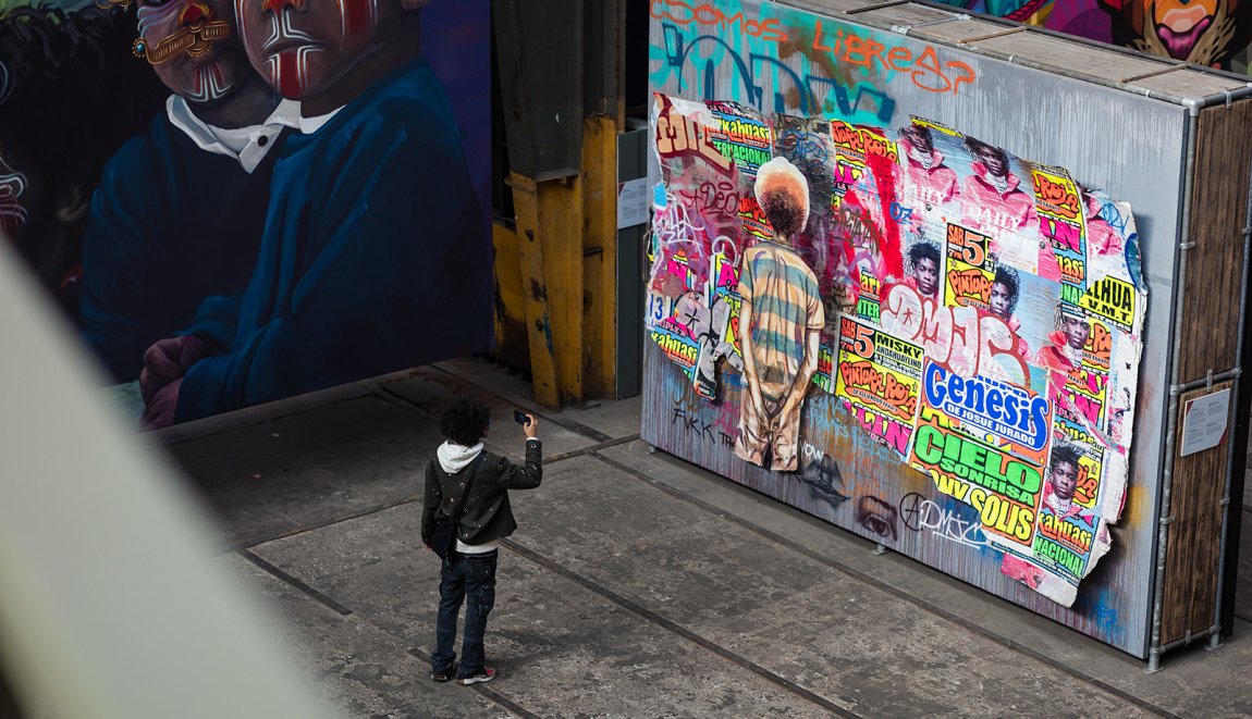 Man takes photo of street art in the STRAAT Museum on the NDSM site in Amsterdam Man takes photo of street art in the STRAAT Museum on the NDSM site in Amsterdam