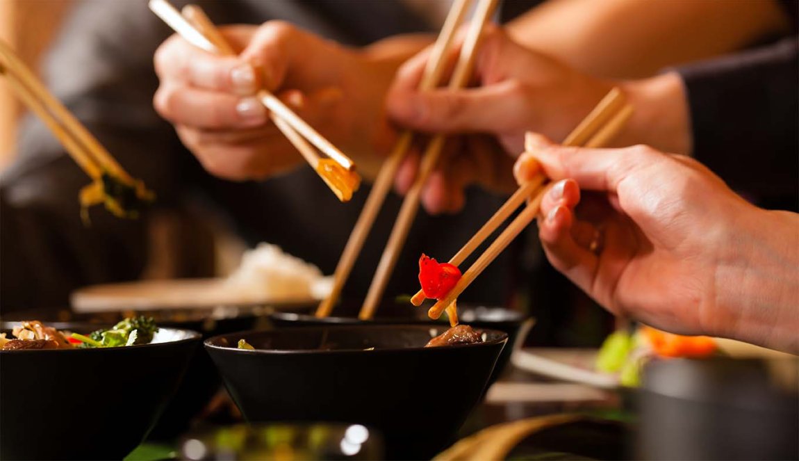 Young people eating in a Thai restaurant