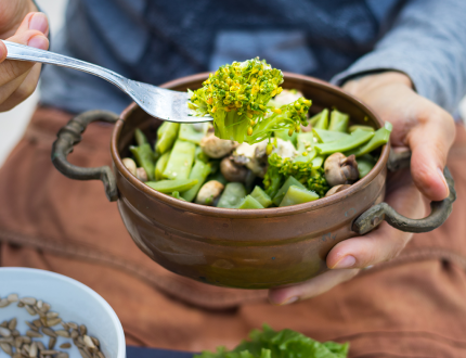 Green greens in a bowl with fork. Vegan vegetarian healty food .