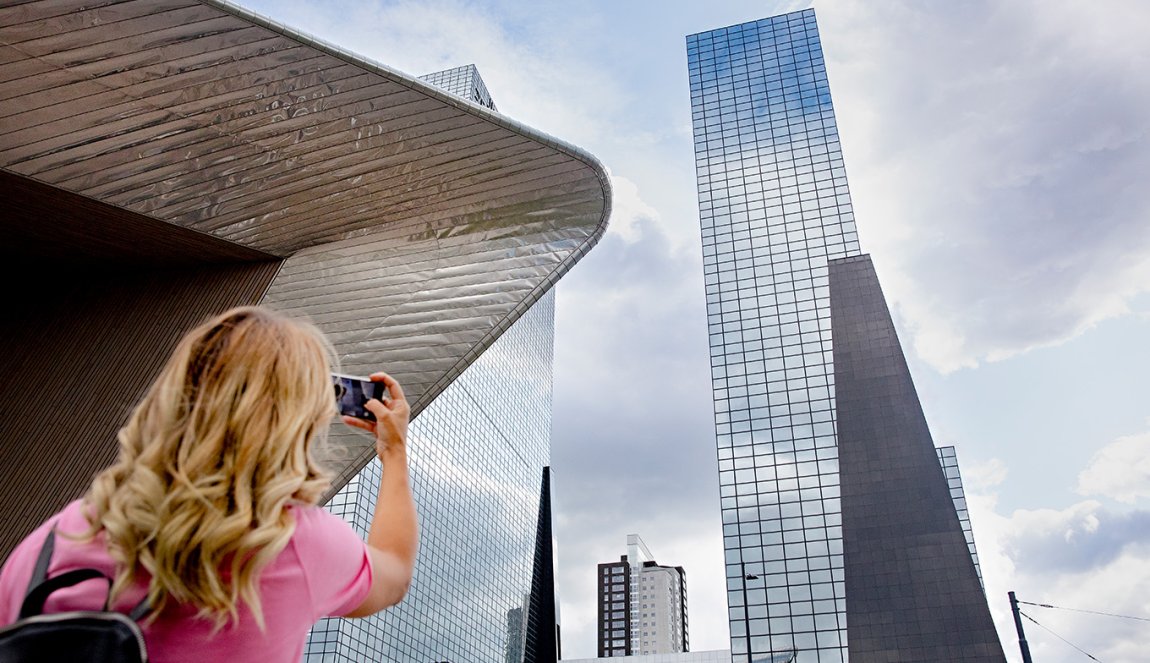 Lady takes picture of Delftse Poort in Rotterdam