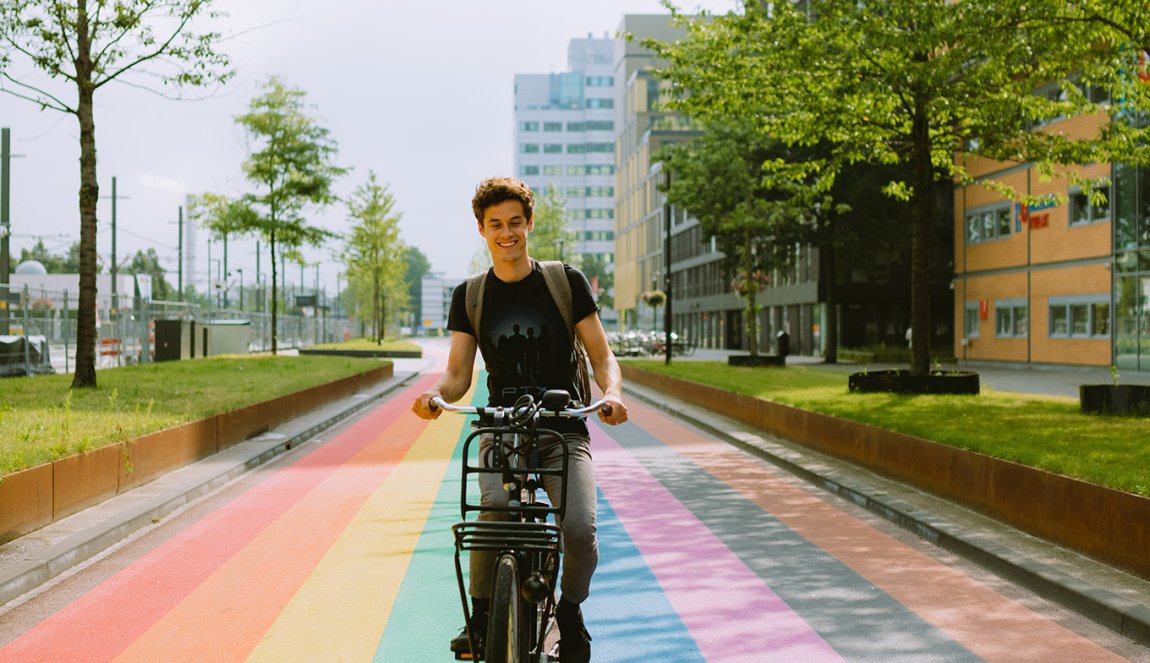 Man cycles along rainbow bike path in Utrecht