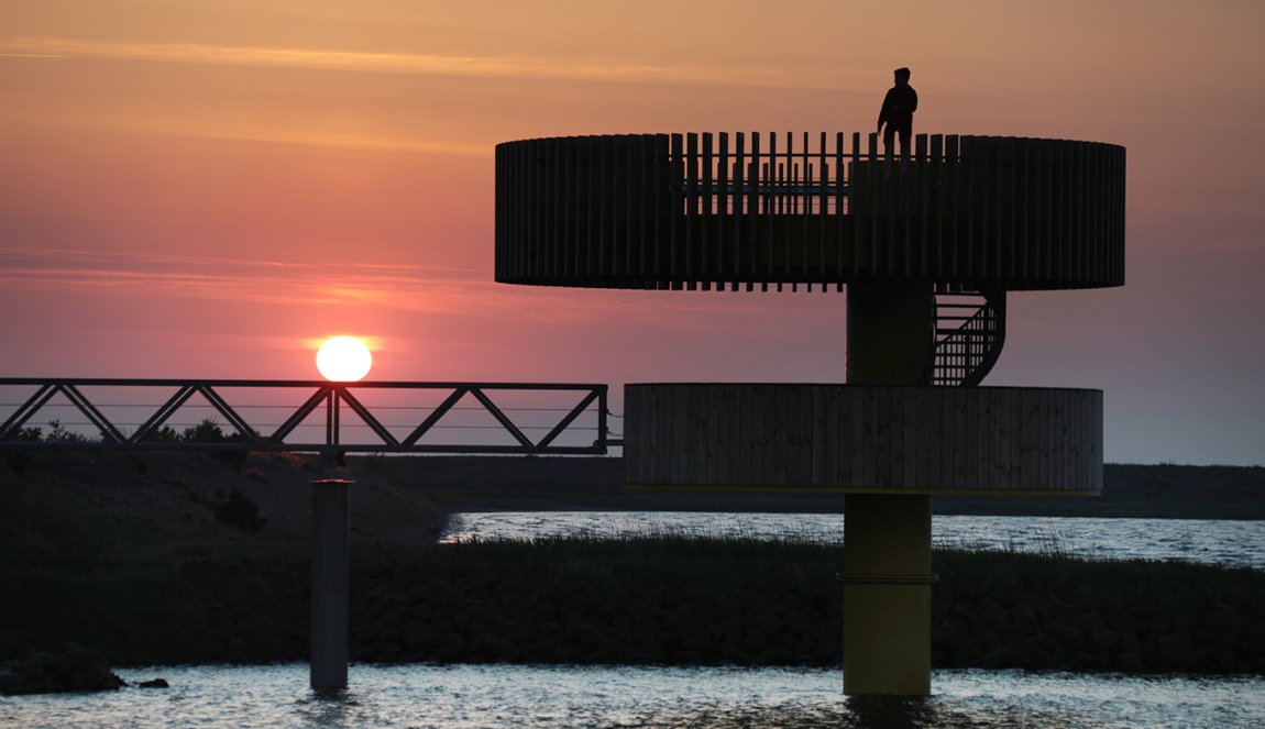 Den Oever viewpoint overlooking the harbour, mud flats, piers and sea